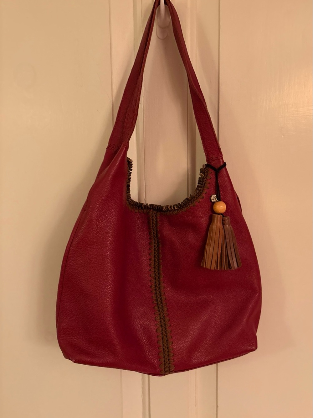 The Sak Huntley Hobo Bag Crimson Red Pebbled Leather Crochet Detail Tassel Charm
